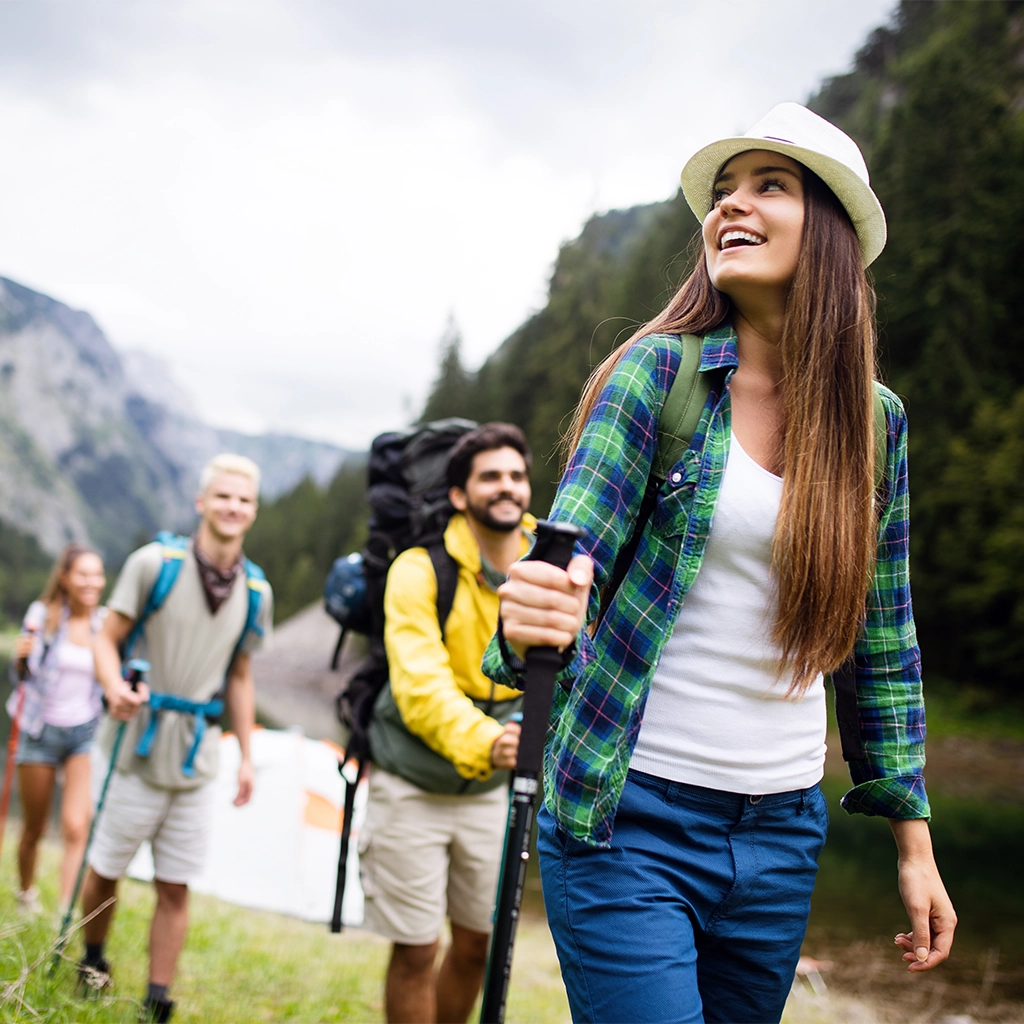 group of young friends hiking in nature and outdoors