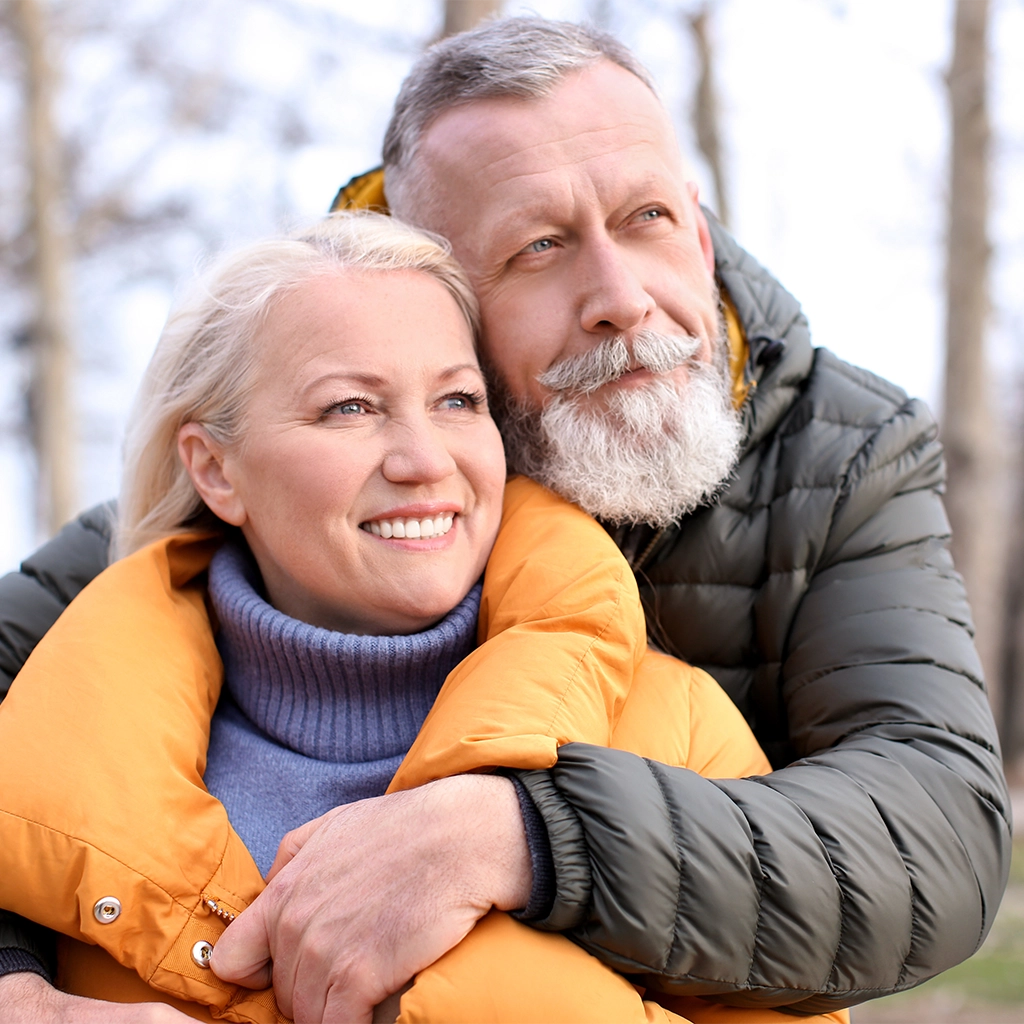 happy mature couple hugging outdoors