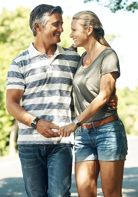 mature couple holding hands walking outdoor nature park